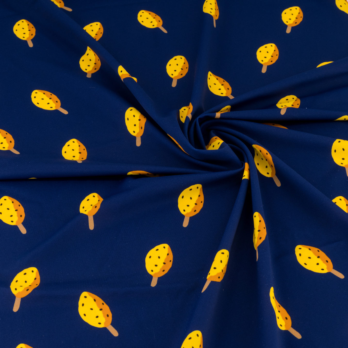 A navy blue fabric featuring yellow granadilla lollies.